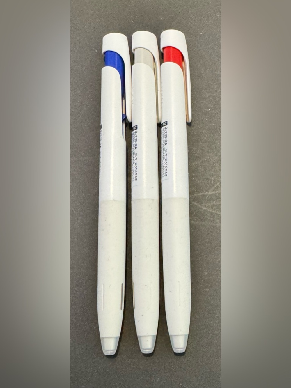 White Retractable Ballpoint Pen Set with Blue, Black, and Red Accents